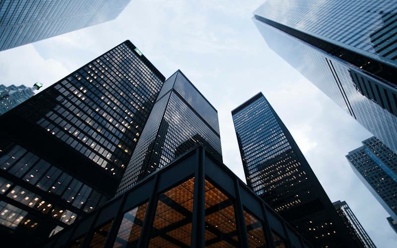 Modern office building exterior with glass facade reflecting sunlight